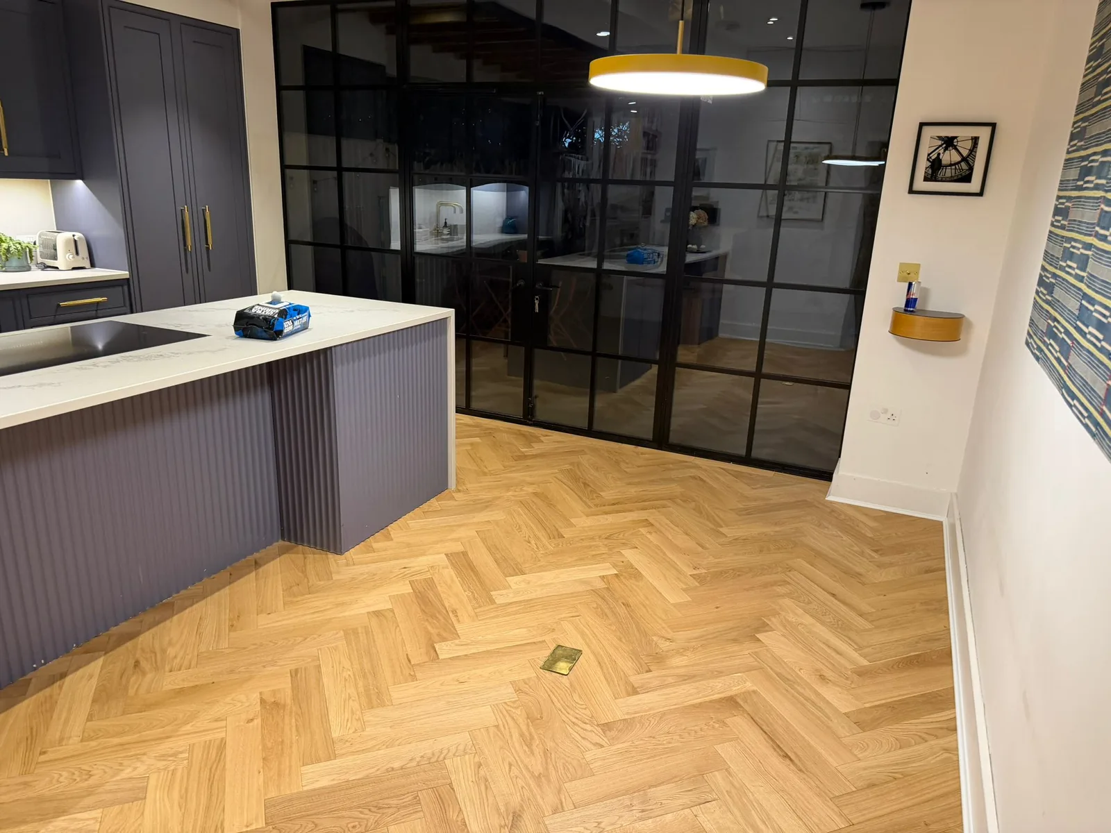 American Oak Herringbone Mellow engineered oak flooring fitted in a kitchen-diner by Crittall doors, Richmond