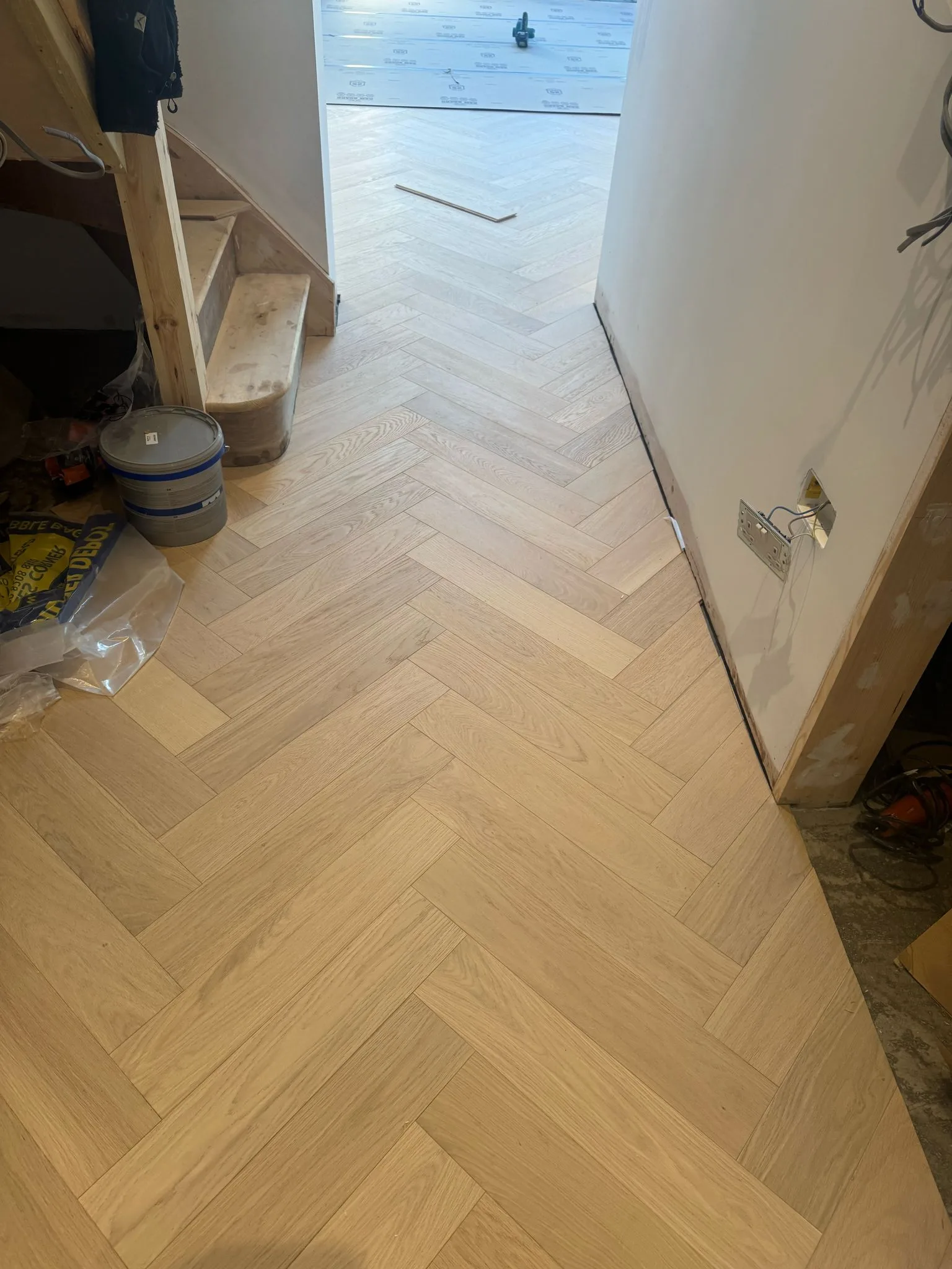 White-Oiled Oak Herringbone 90×450 engineered oak flooring fitted in a staircase hall, Rickmansworth