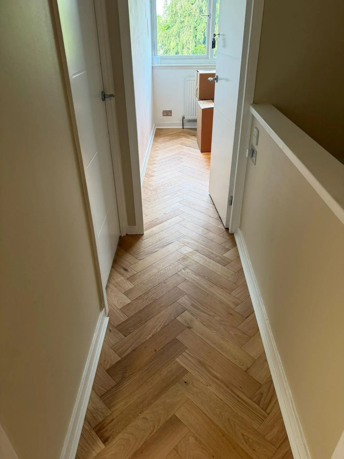 American Oak Herringbone Pale Ash engineered oak flooring fitted in a upstairs landing, Wimbledon