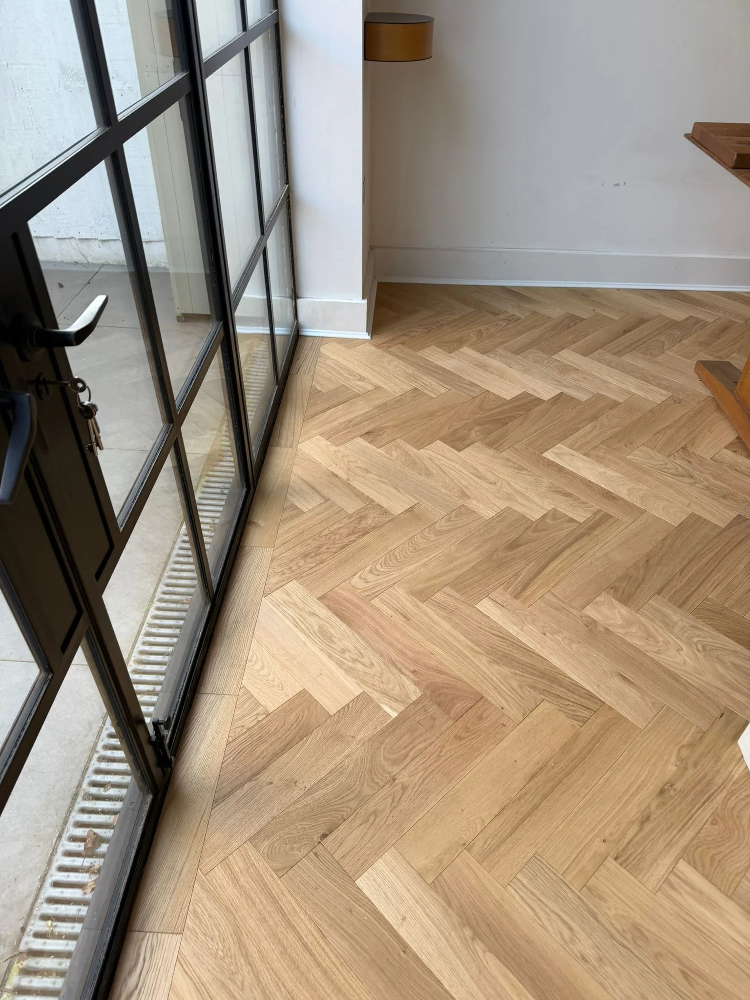 American Oak Herringbone Mellow engineered oak flooring fitted in a garden-room doors, Richmond