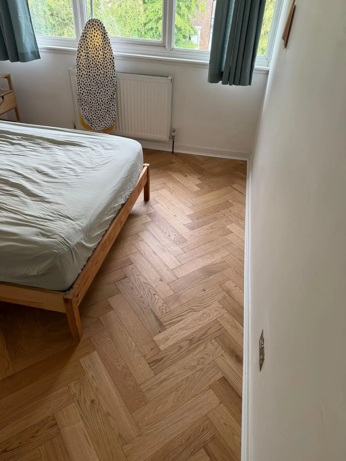 American Oak Herringbone Mellow engineered oak flooring fitted in a bedroom, Ruislip