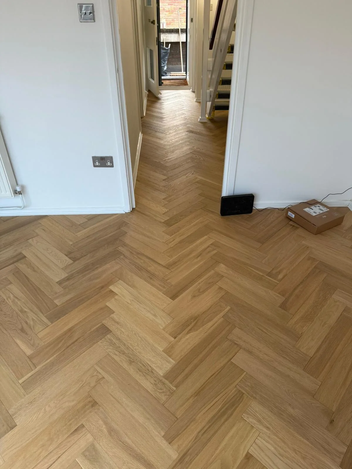 Brushed Matt-Lacquered Herringbone 125×600 engineered oak flooring fitted in a hall and landing, Twickenham