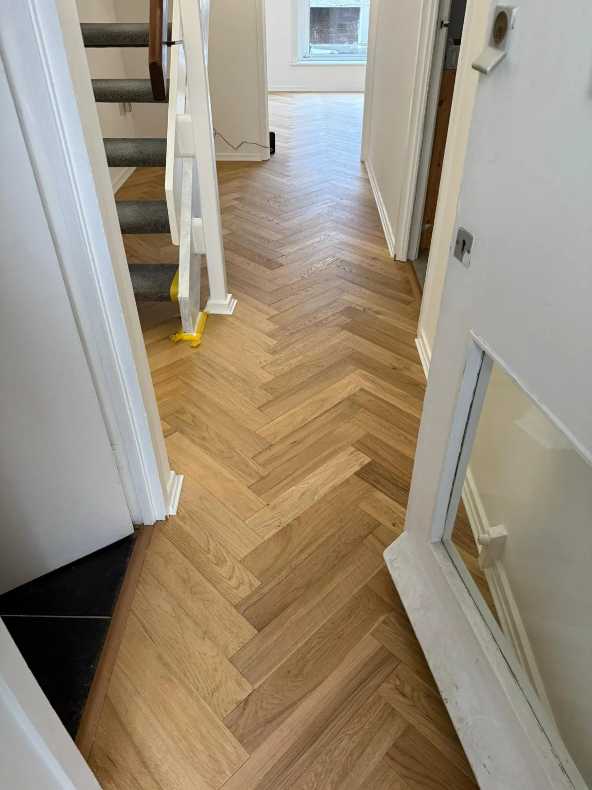 American Oak Herringbone Mellow engineered oak flooring fitted in a hallway and stairs, Watford