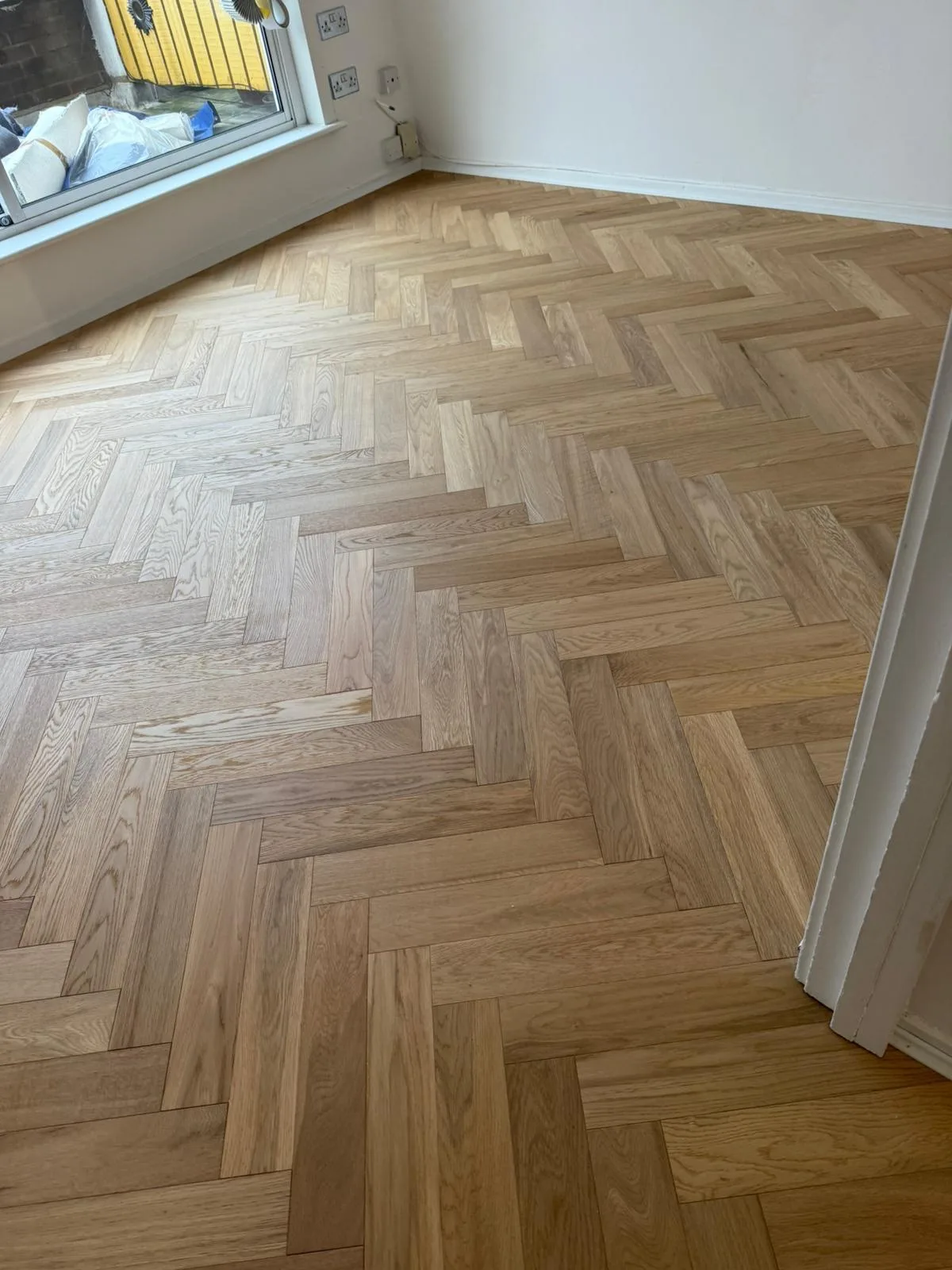 American Oak Herringbone Pale Ash engineered oak flooring fitted in a front reception, Ealing