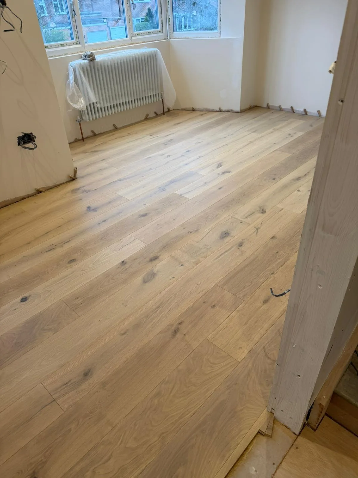 Invisible-Finish Oak Planks 190mm engineered oak flooring fitted in a first-floor reception, mid-installation, Notting Hill