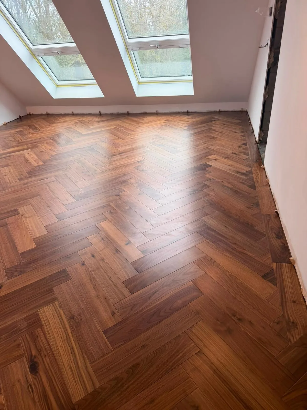 American Oak Herringbone Rich Walnut engineered oak flooring fitted in a loft bedroom, Pinner