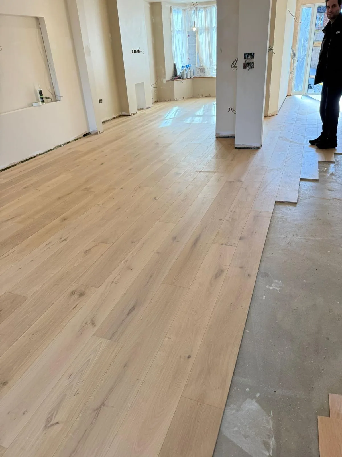 Invisible-Finish Oak Planks 190mm engineered oak flooring fitted in a open-plan extension, mid-installation, Weybridge
