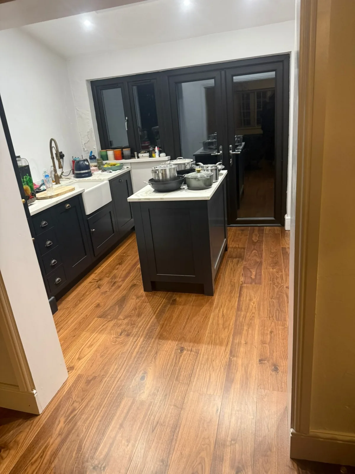 Walnut-toned oak plank flooring in a shaker kitchen, Pinner
