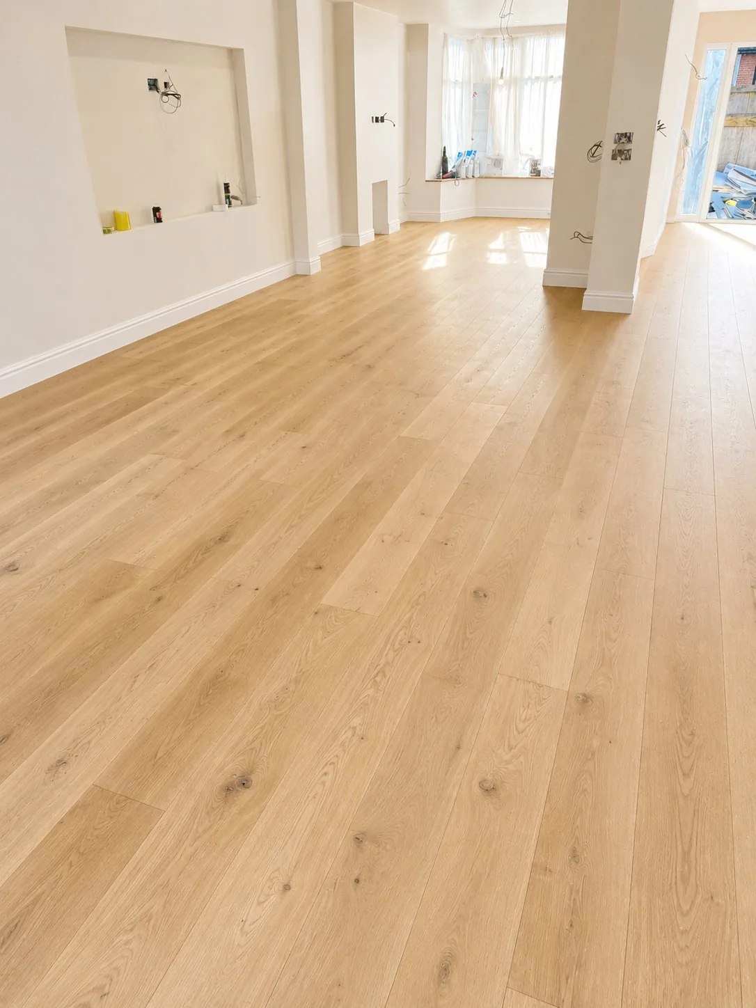 Pale wide plank oak flooring in a bay-window living room, Wimbledon